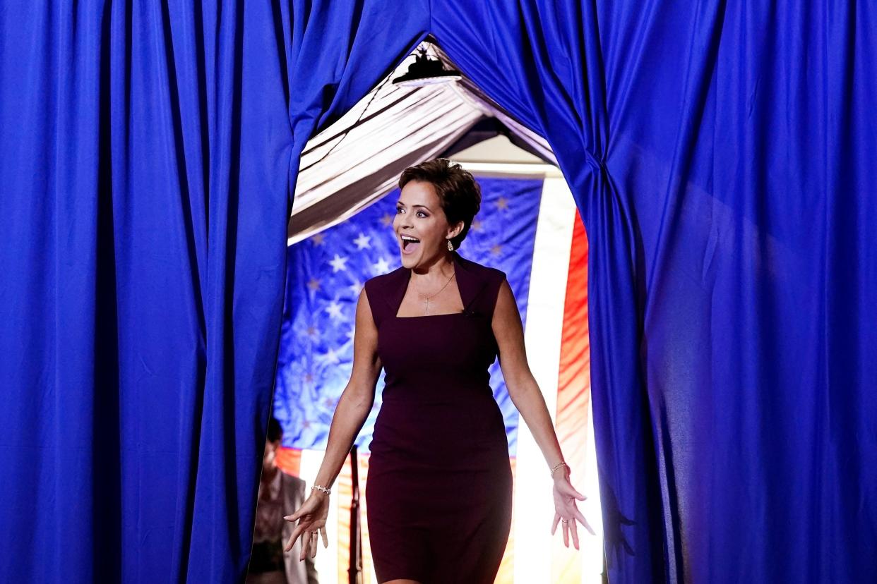 Kari Lake, a Republican candidate for Arizona governor, reacts to the crowd as she walks onto the stage to speak at a Save America Rally on July 22, 2022, in Prescott.