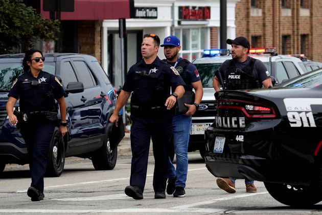 Police search the downtown area in Highland Park after a shooting at a Fourth of July parade on July 4, 2022.