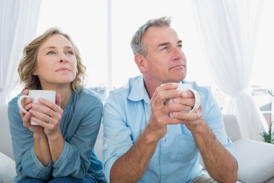 Two people holding coffee cups.