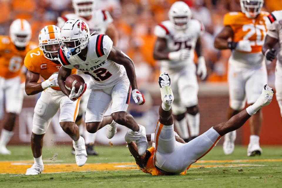 Ball State wide receiver Jayshon Jackson (12) is tripped by Tennessee defensive back Jaylen McCollough during the first half of an NCAA college football game Thursday, Sept. 1, 2022, in Knoxville, Tenn. (AP Photo/Wade Payne)