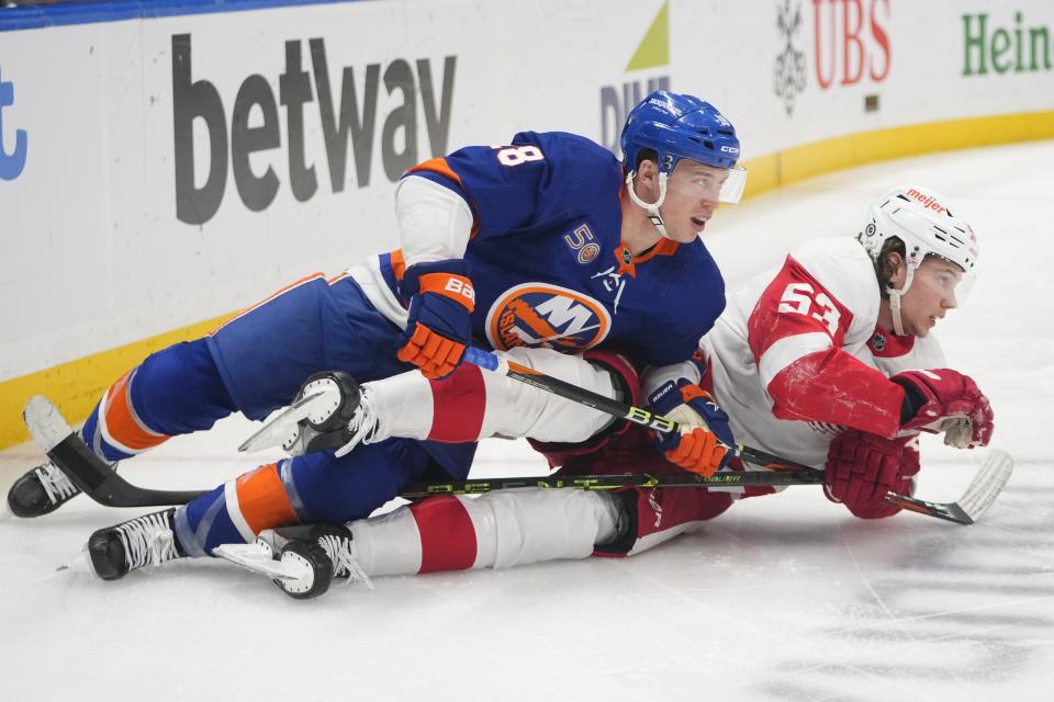 New York Islanders' Anthony Beauvillier (18) and Detroit Red Wings' Moritz Seider (53) fall down while fighting for postion during the second period at UBS Arena in Elmont, New York, on Friday, Jan. 27, 2023.