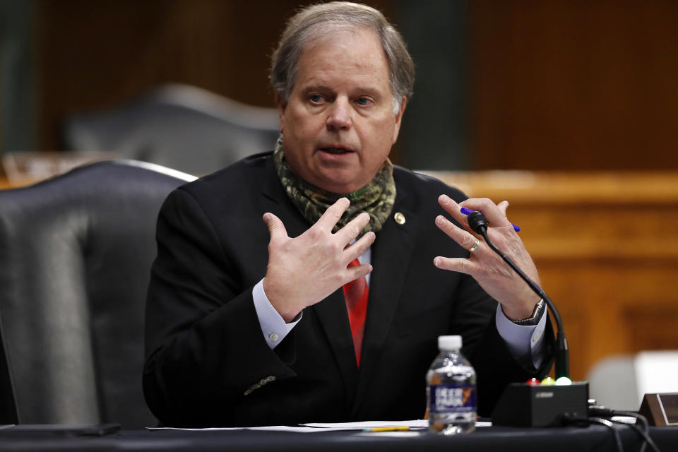 FILE - In this Thursday, May 7, 2020, file photo, U.S. Sen. Doug Jones, D-Ala., speaks at Capitol Hill in Washington. Tommy Tuberville’s quest for a seat in the U.S. Senate is powered by the reputation he gained as Auburn University’s football coach. But in the years since, the Republican has been mired in business failings, a lawsuit and even a questionable charity that raises money but gives very little away. In trying to raise doubts Tuberville's fitness for office, Jones has pointed to Tuberville’s involvement in a failed hedge fund. (AP Photo/Andrew Harnik, Pool, File)