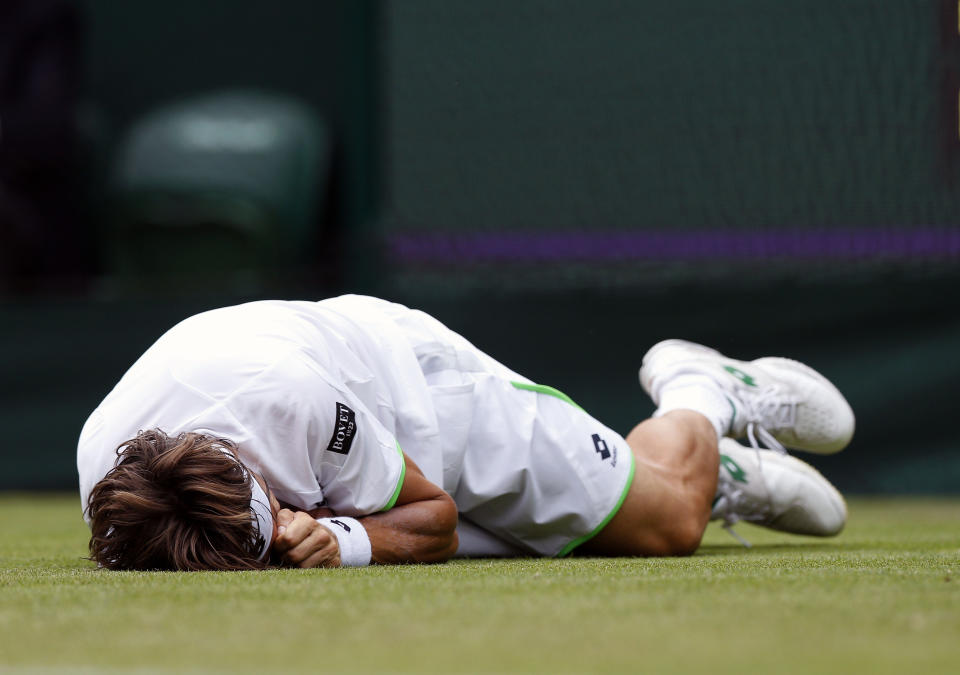 Spain's David Ferrer slips during his match against Argentina's Martin Alund during day Two of the Wimbledon Championships at The All England Lawn Tennis and Croquet Club, Wimbledon.