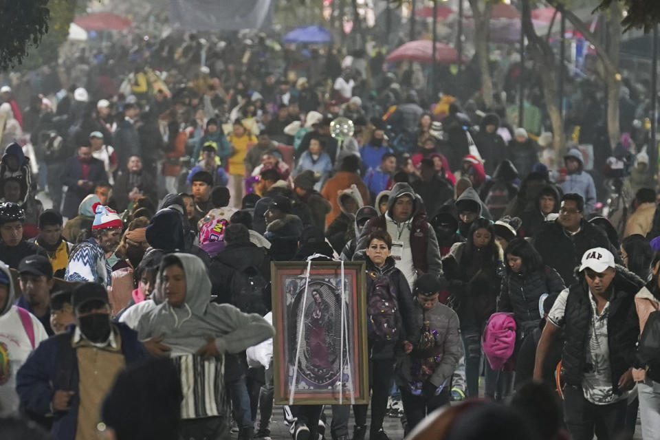 Pilgrims arrive to the Basilica of Guadalupe on her feast day in Mexico City, early Tuesday, Dec. 12, 2023. Devotees of Our Lady of Guadalupe gather for one of the world's largest religious pilgrimages on the anniversary of one of several apparitions of the Virgin Mary witnessed by an Indigenous Mexican man named Juan Diego in 1531. (AP Photo/Marco Ugarte)