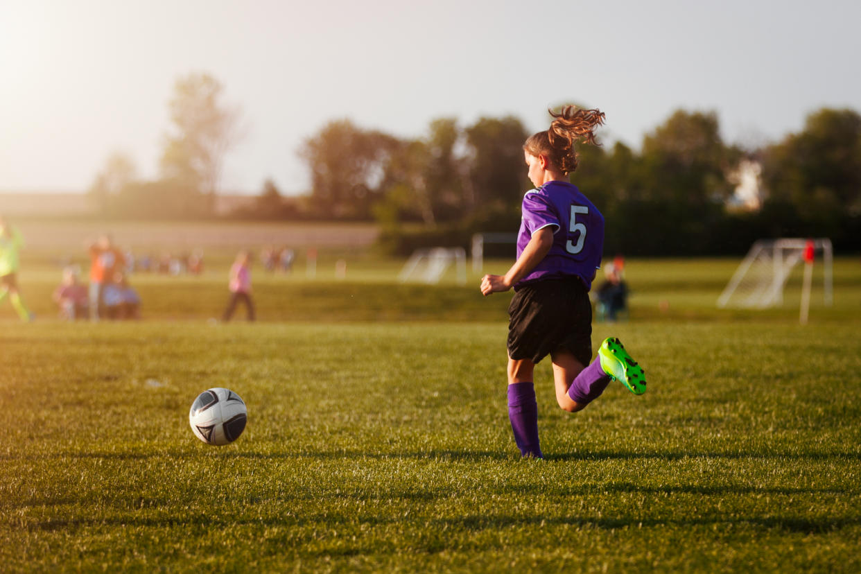 girl playing in soccer game