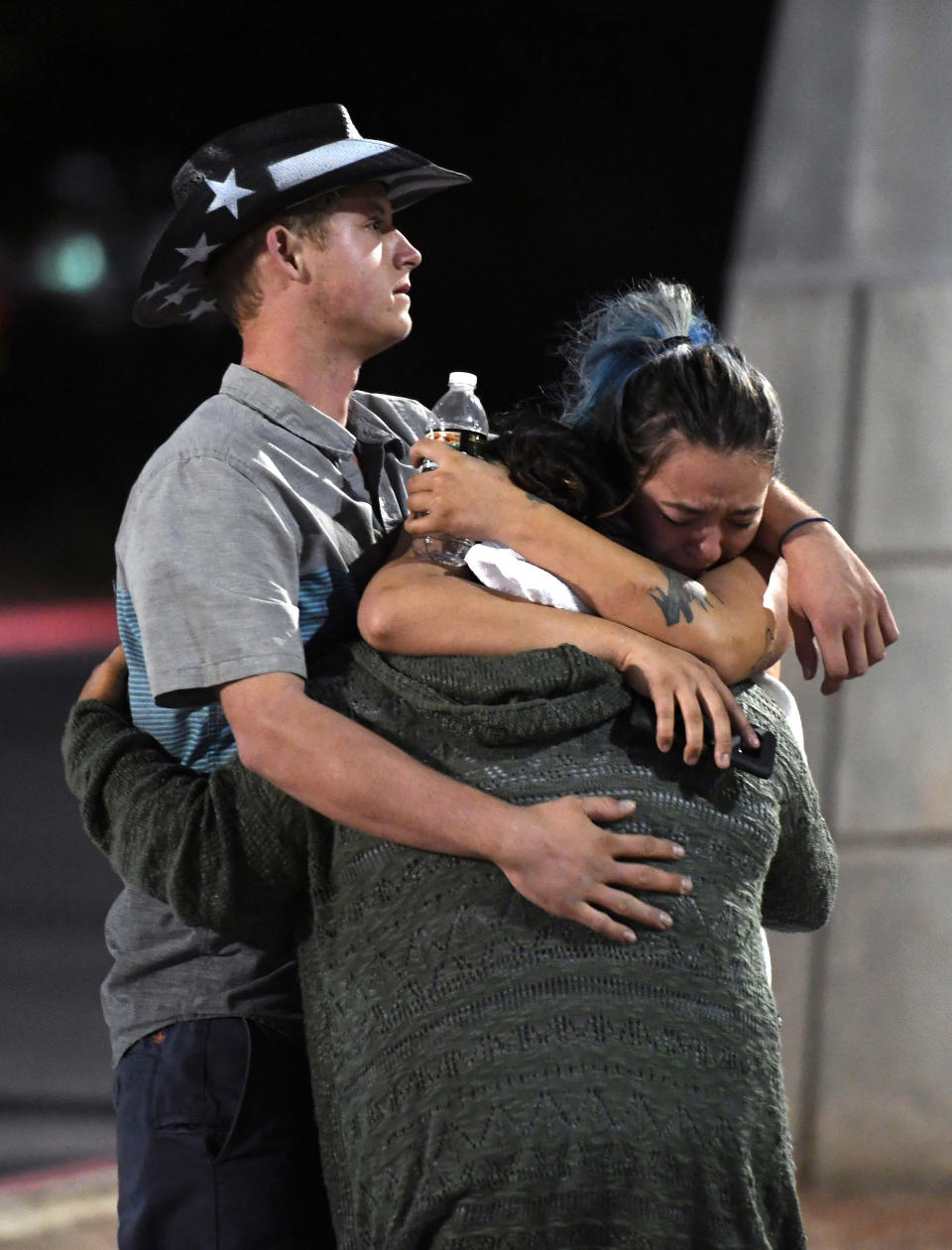 People hug and cry outside the Thomas &amp; Mack Center after a mass shooting at the Route 91 Harvest country music festival on Oct. 2, 2017, in Las Vegas.