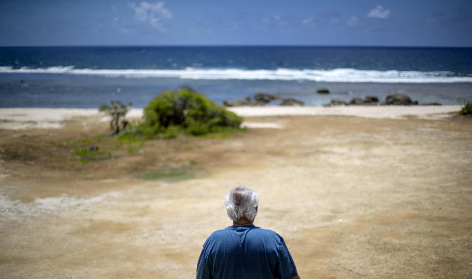 Leo Tudela visits the beach where he says he was sexually abused as a boy by a priest on a Boy Scout outing in Yona, Guam, Thursday, May 9, 2019. "In those days the Catholic priests and the brothers are like God. You don't question them," he said. Tudela remembers burying his face in his blanket and sobbing. Even now, more than six decades later, the memories of that night trigger anguish. "I never forget this place," he said. The Rev. Louis Brouillard acknowledged abuse allegations before he died. (AP Photo/David Goldman)