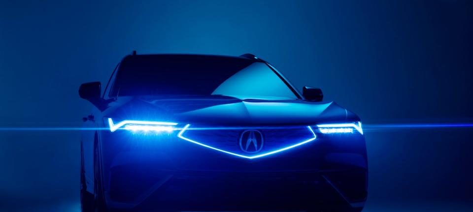The front end of the Acura ZDX electric SUV, with lights illuminated. 