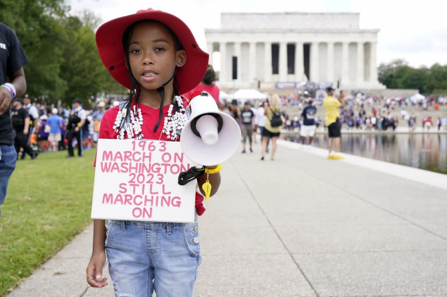 T’Kyrra Terrell, 6, who her grandmother says has been marching and protesting since she was 2, poses for a portrait on her way to the 60th Anniversary of the March on Washington at the Lincoln Memorial, Saturday, Aug. 26, 2023, in Washington. (AP Photo/Jacquelyn Martin)