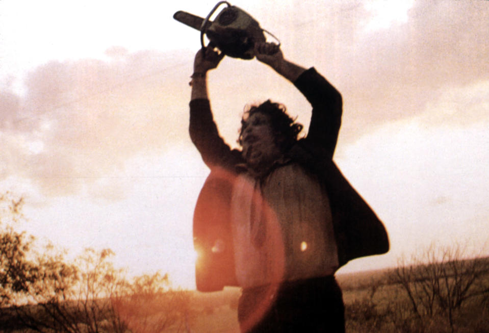 Gunnar Hansen holding up a chainsaw.