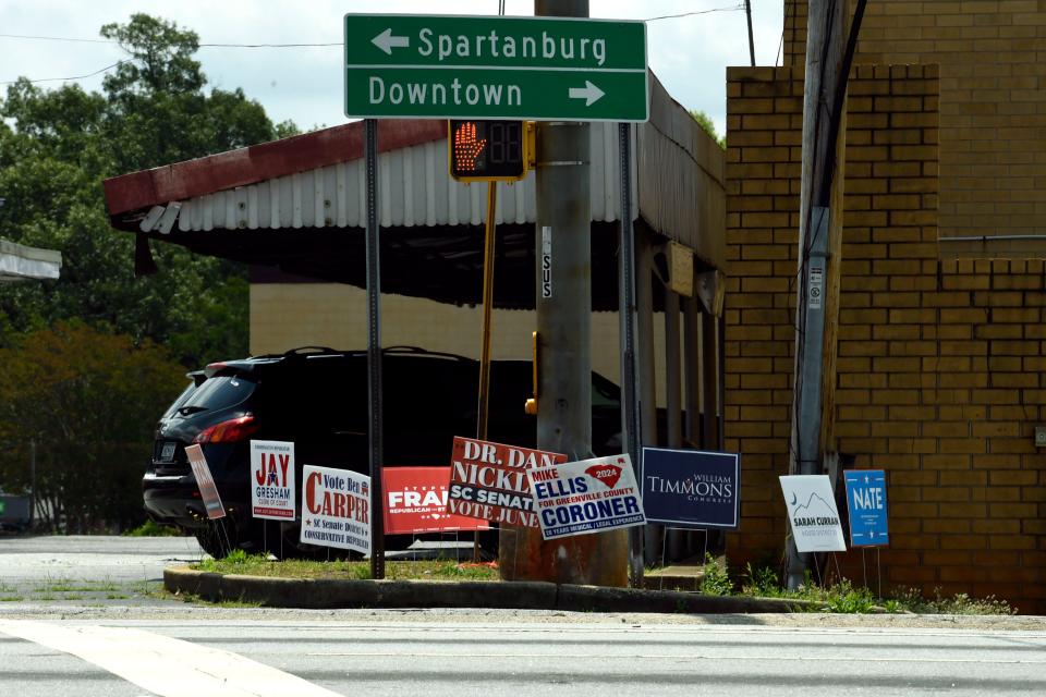 Political signs are seen on North Pleasantburg Drive and Wade Hampton Boulevard on Tuesday, June 4, 2024.