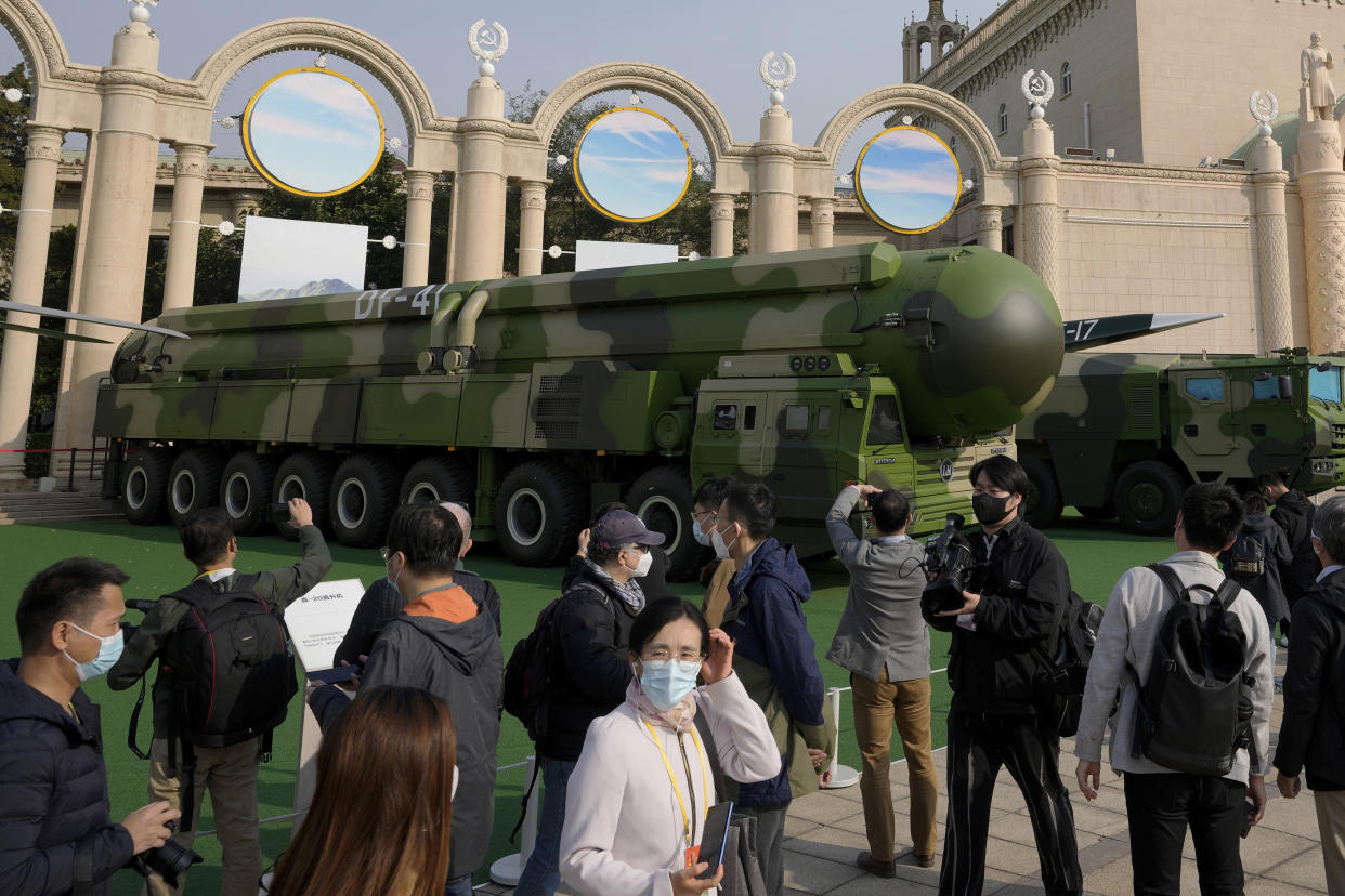 Visitors tour past military vehicles carrying the Dong Feng 41 and DF-17 ballistic missiles at an exhibition highlighting President Xi Jinping and his China's achievements under his leadership, at the Beijing Exhibition Hall in Beijing on Oct. 12, 2022. China strictly adheres to its policy of no first use of nuclear weapons "at any time and under any circumstances," its Defense Ministry said Tuesday, Dec. 6, 2022, in a scathing response to a U.S. report alleging a major buildup in Beijing's nuclear capabilities. (AP Photo/Andy Wong)