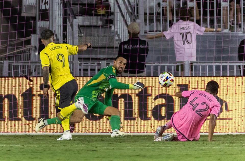Inter Miami midfielder Yannick Bright (42) helps defends the goal as goalkeeper Drake Callender (1) makes a save the against Columbus Crew forward Cucho Hernández (9) in second half of their MLS match at Chase Stadium on Wednesday, June 19, 2024, in Fort Lauderdale, Fla.