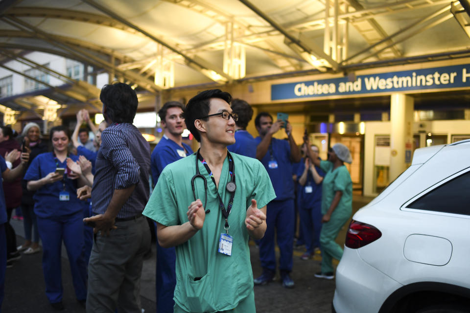 NHS staff applaud outside the Chelsea and Westminster Hospital in London during the weekly "Clap for our Carers", Thursday, April 16, 2020. The applause takes place across Britain every Thursday at 8pm local time to show appreciation for healthcare workers, emergency services, armed services, delivery drivers, shop workers, teachers, waste collectors, manufacturers, postal workers, cleaners, vets, engineers and all those helping people with coronavirus and keeping the country functioning while most people stay at home in the lockdown. (AP Photo/Alberto Pezzali)