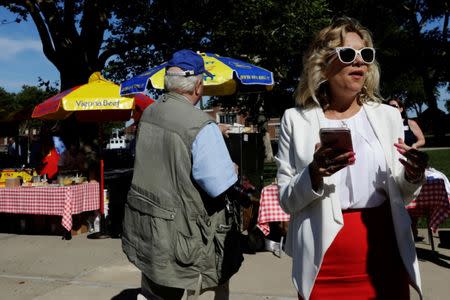 A woman stands near hot dogs stands as vendors celebrate a newly opened exhibit at Ellis Island highlighting the immigrant history behind the "Hot Dog" in New York City, U.S., June 28, 2017. REUTERS/Lucas Jackson