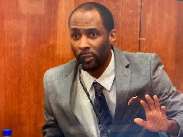 Theodore Edgecomb testifies at his homicide trial Tuesday, showing how he said he told immigration lawyer Jason Cleereman to stop advancing toward him. A jury on Wednesday found him guilty of reckless homicide in the road rage shooting that killed Cleereman.