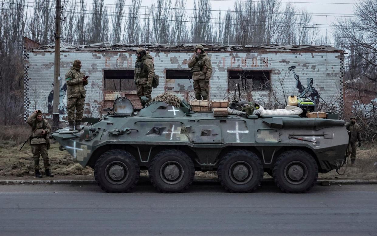 Ukrainian soldiers stand on an armoured personnel carrier yesterday before heading to the frontline in Donetsk region - Andriy Dubchak/AP