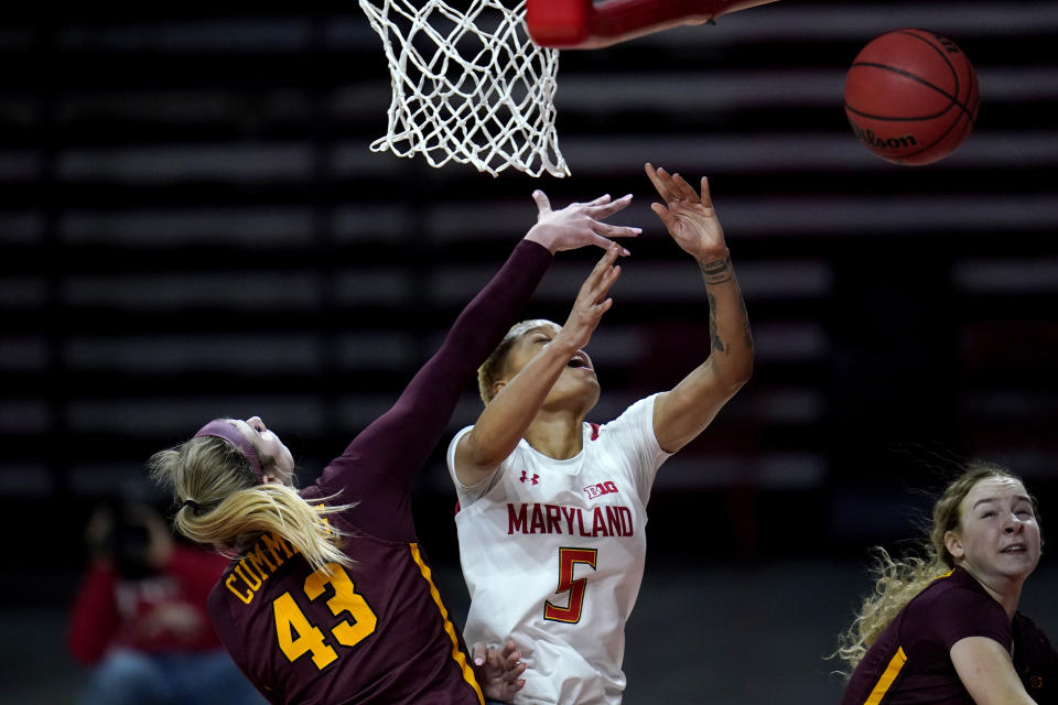 Maryland forward Alaysia Styles (5) loses the ball while going up for a shot against Minnesota forward Grace Cumming (43) during the second half of an NCAA college basketball game, Saturday, Feb. 20, 2021, in College Park, Md. Maryland won 94-62. (AP Photo/Julio Cortez)