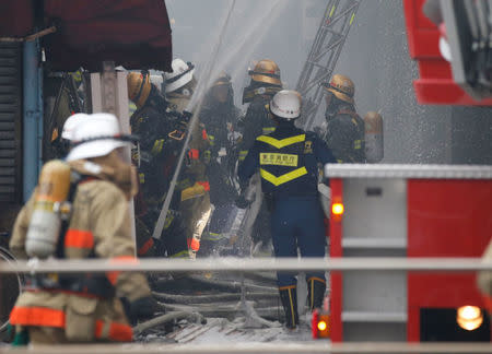 Firefighters operate at the fire site at Tokyo's Tsukiji fish market in Tokyo, Japan August 3, 2017. REUTERS/Toru Hanai