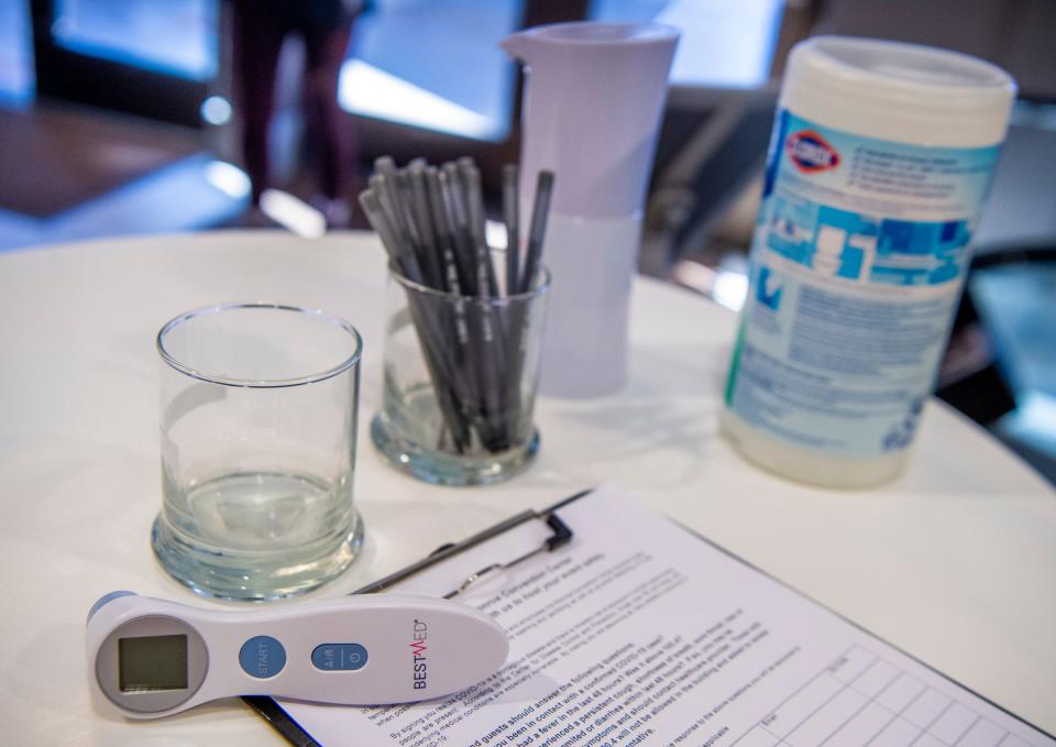 The check-in station, which includes a temperature check, is seen at the COVID-19 vaccination clinic in the Monroe Convention Center in downtown Bloomington. The clinic will operate on Indiana University’s Bloomington campus starting March 29. (Rich Janzaruk / Herald-Times)