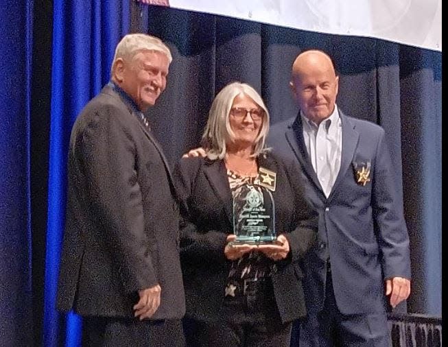 Effingham County Sheriff Jimmy McDuffie, left, and Georgia Sheriff's Association Director Terry Norris, right, presented Jackson County Sheriff Janis Mangum with the association's 2023 Sheriff of the Year award on Wednesday, July 26.