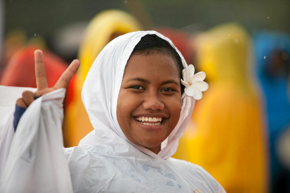 <p>A pilgrim covered in raincoat smiles during the World Youth Day in Krakow, Poland, July 26, 2016. (Agencja Gazeta/Kuba Ociepa/via REUTERS)</p>