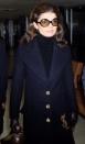 <p>Ready to board a flight at Heathrow Airport, Jackie is the perfect example of 1970s elevated style: a navy turtleneck and wool double-breasted coat paired with sunglasses and leather gloves and handbag all sing together.<br></p>