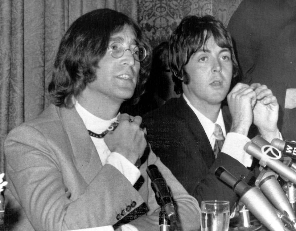 Members of the British pop group The Beatles, John Lennon, left,and Paul McCartney, announce that Beatles Ltd., is being reorganized for bigger things as Apple Corps Ltd., in New York, NY, May 15, 1968. The new company, owned equally by all four Beatles, will make films, produce records and own clothing stores in London. (AP Photo)