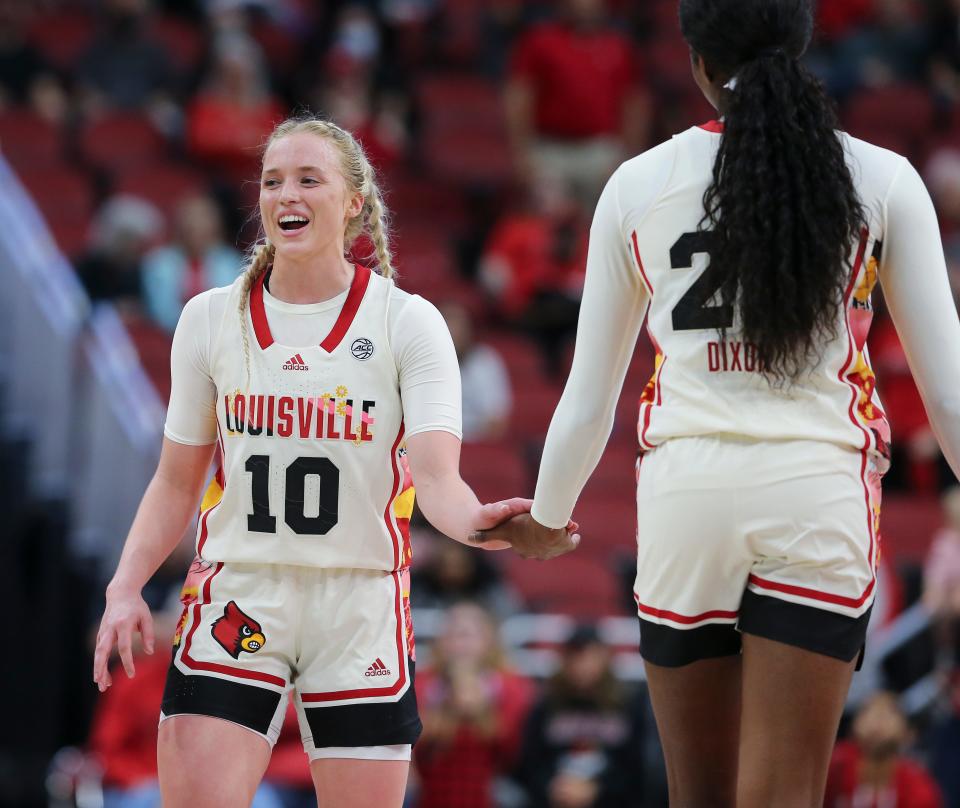U of L's Hailey Van Lith (10) and Liz Dixon (22) celebrated a win against Miami following their game at the Yum Center in Louisville, Ky. on Feb. 23, 2023.
