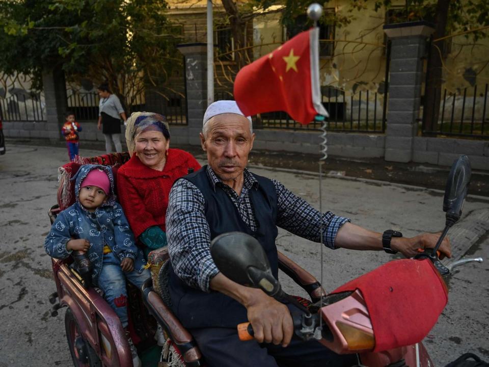 A man driving a vehicle in an Uighur neighbourhood in Xinjiang provinceAFP/Getty