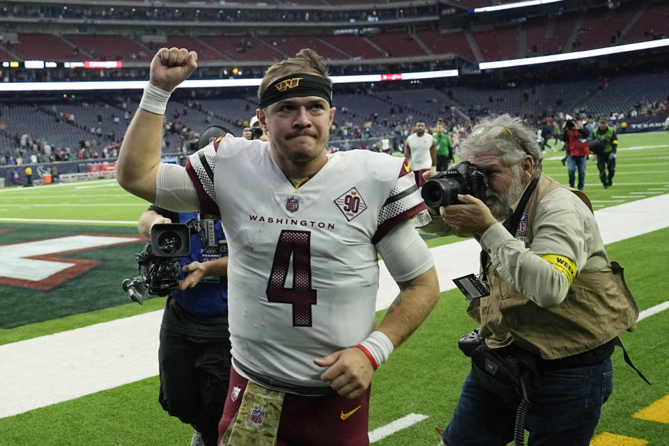 Washington Commanders quarterback Taylor Heinicke (4) runs off the field following the team's win over the Houston Texans in an NFL football game Sunday, Nov. 20, 2022, in Houston. (AP Photo/David J. Phillip)