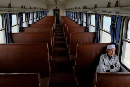 An ethnic Uighur man sits on the train from Hotan to Kashgar, Xinjiang Uighur Autonomous Region, China, March 22, 2017. REUTERS/Thomas Peter