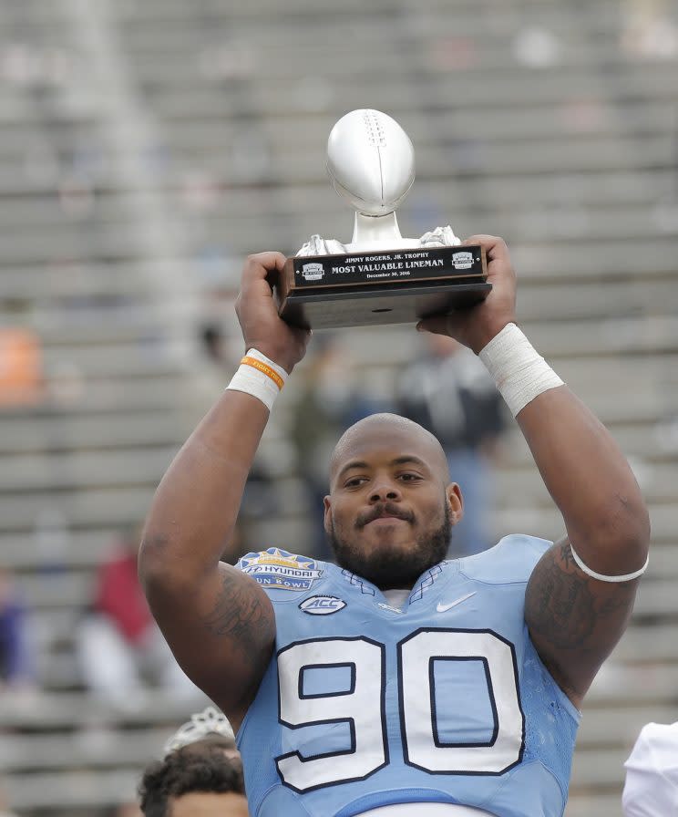 North Carolina defensive tackle Nazair Jones holds up his Jimmy Rogers Jr. Most Valuable Lineman Trophy after the Sun Bowl against Stanford. (AP) 