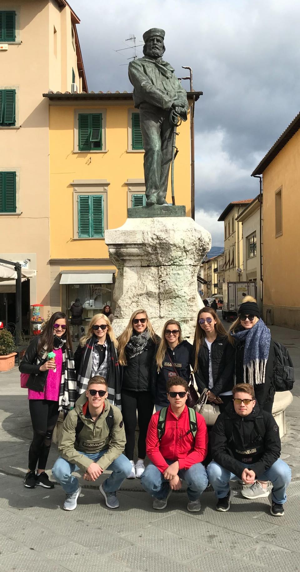 A Corning-Painted Post student group poses in front of the Piazza Masaccio in San Giovanni Valdarno, Italy during a 2018 visit. Students are now planning to return for the first time since 2020.