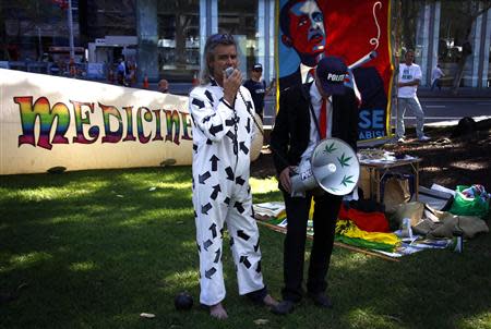 BJ Futter (L), the Australian Senate candidate for the Help End Marijuana Prohibition (HEMP) Party, wears an outfit depicting as a convict and a toy ball and chain around his ankle as he speaks during their launch of the national election campaign in central Sydney September 2, 2013. REUTERS/David Gray