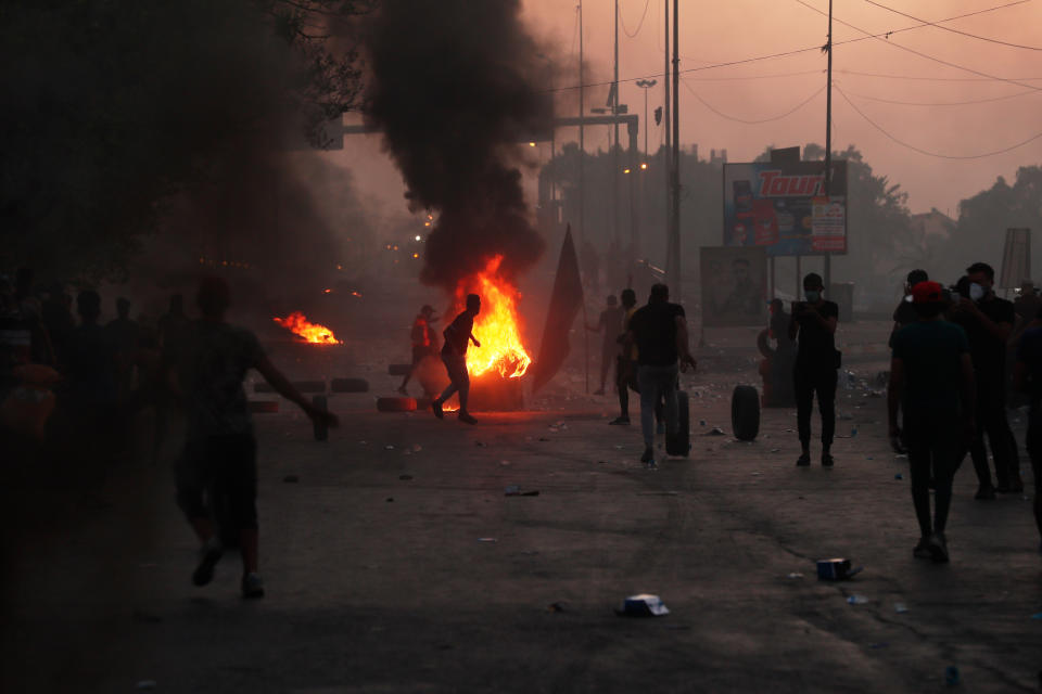 Anti-government protesters set fires and close a street during a demonstration in Baghdad, Iraq, Saturday, Oct. 5, 2019. The spontaneous protests which started Tuesday in Baghdad and southern cities were sparked by endemic corruption and lack of jobs. Security forces responded with a harsh crackdown, with dozens killed. (AP Photo/Hadi Mizban)