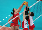 LONDON, ENGLAND - AUGUST 07: Yunli Xu #11 of China tries to get the ball past Ai Otomo #11 and Risa Shinnabe #12 of Japan during Women's Volleyball on Day 11 of the London 2012 Olympic Games at Earls Court on August 7, 2012 in London, England. (Photo by Elsa/Getty Images)