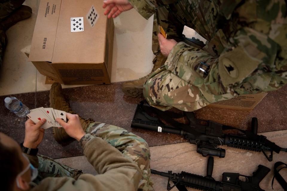 <p>Members of the National Guard play cards in the Capitol Visitors Center on Capitol Hill in Washington, DC, January 13, 2021.</p>