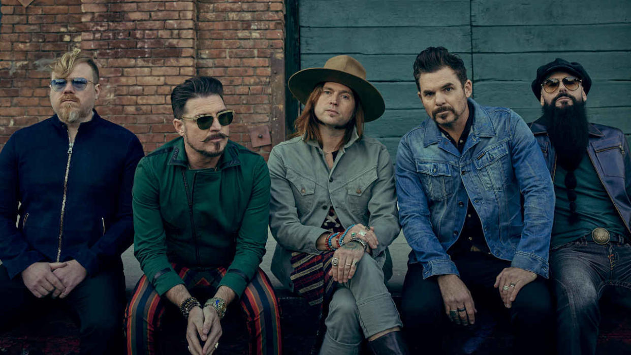  Rival Sons sitting in the street 