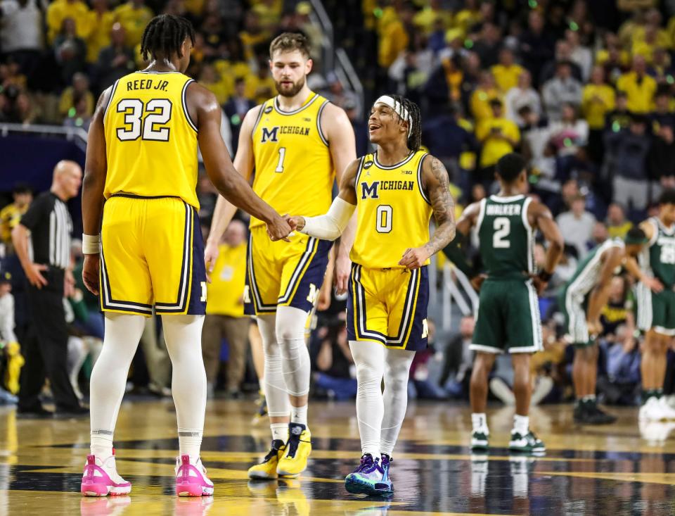 Michigan guard Dug McDaniel (0), center, celebrates a play against Michigan State with forward Tarris Reed Jr. (32) during the second half at Crisler Center in Ann Arbor on Saturday, Feb. 18, 2023.