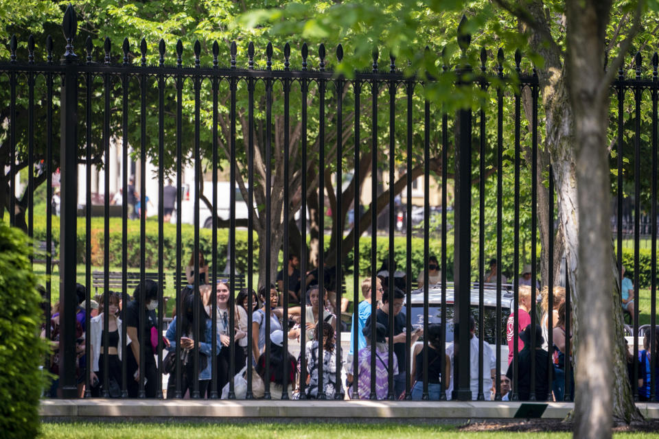 Fans of K-pop supergroup BTS stand along Pennsylvania Avenue at the gate of the North Lawn of the White House in Washington, Tuesday, May 31, 2022. (AP Photo/Andrew Harnik)