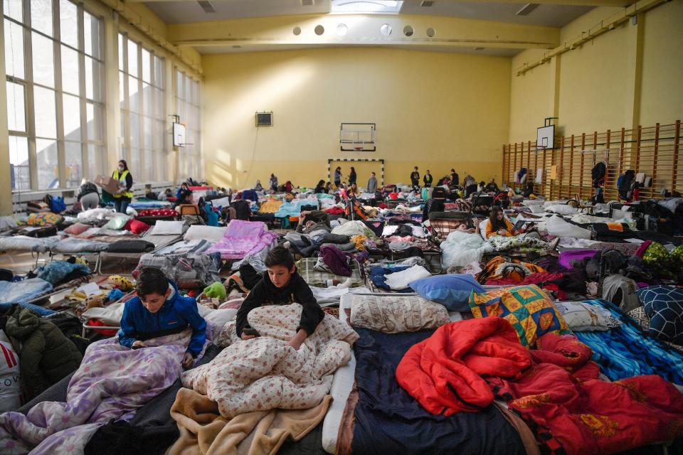 Children rest in a temporary shelter for Ukraine's refugees in a school in Przemysl,  near the Ukrainian-Polish borders on March 14, 2022. - Almost 2.7 million people have fled the war in Ukraine, more than 100,000 of them in the past 24 hours, the UN on March 13, 2022. More than half have gone to Poland. (Photo by Louisa GOULIAMAKI / AFP) (Photo by LOUISA GOULIAMAKI/AFP via Getty Images)