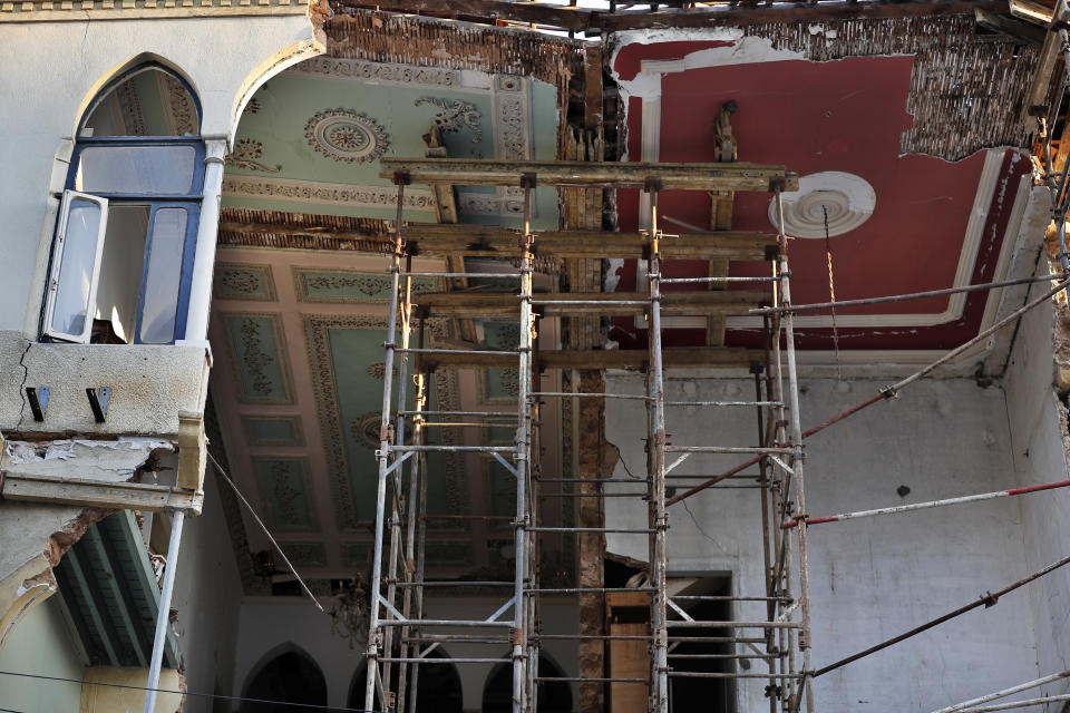 A heritage house that was destroyed in Aug. 4 explosion that hit the seaport of Beirut, is seen hold by scaffolding, in Beirut, Lebanon, Tuesday Aug. 25, 2020. In the streets of Beirut historic neighborhoods, workers are erecting scaffolding to support buildings that have stood for more than a century - now at risk of collapse after the massive Aug. 4 explosion that tore through the capital. (AP Photo/Hussein Malla)