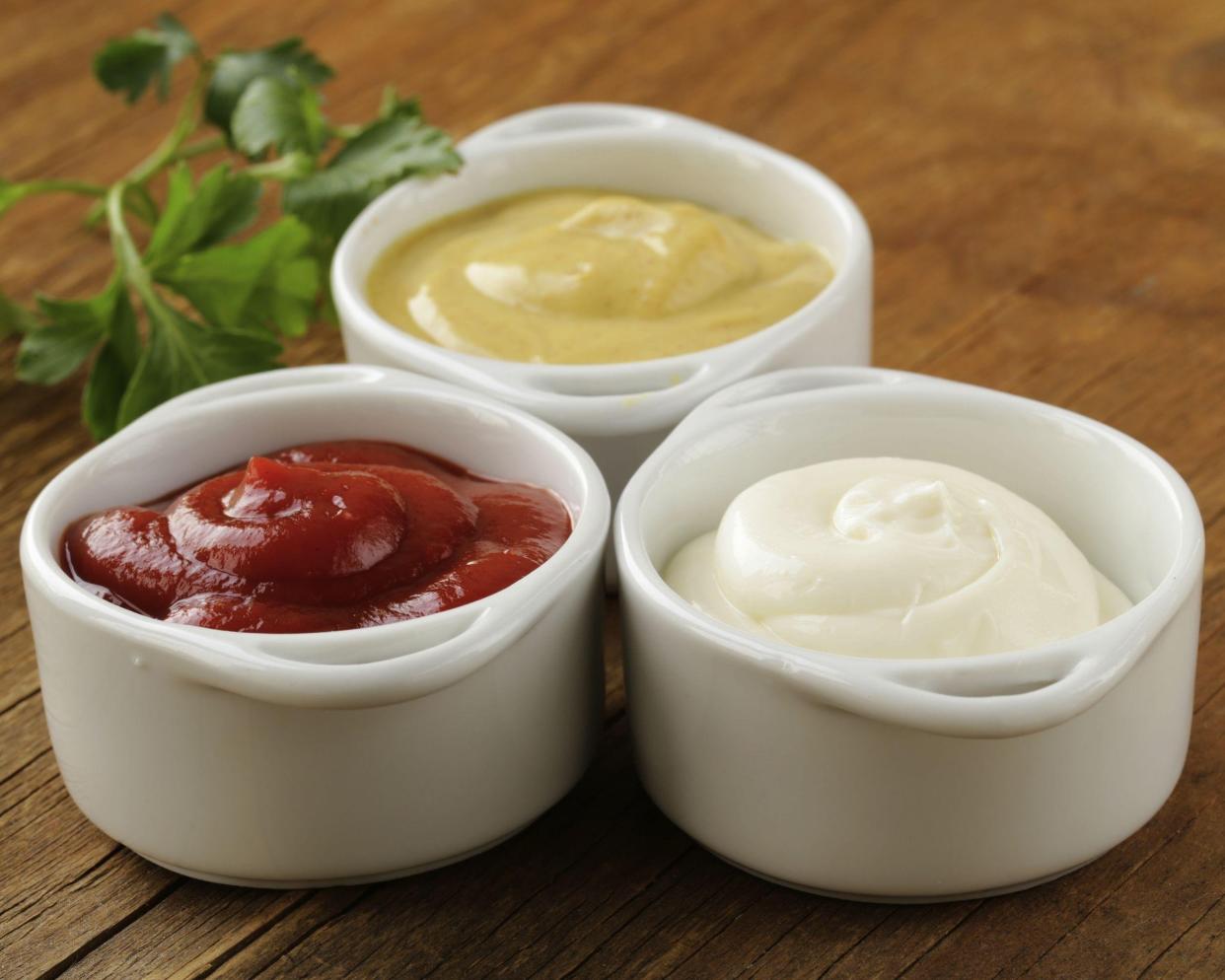 Condiments in white bowls on a table