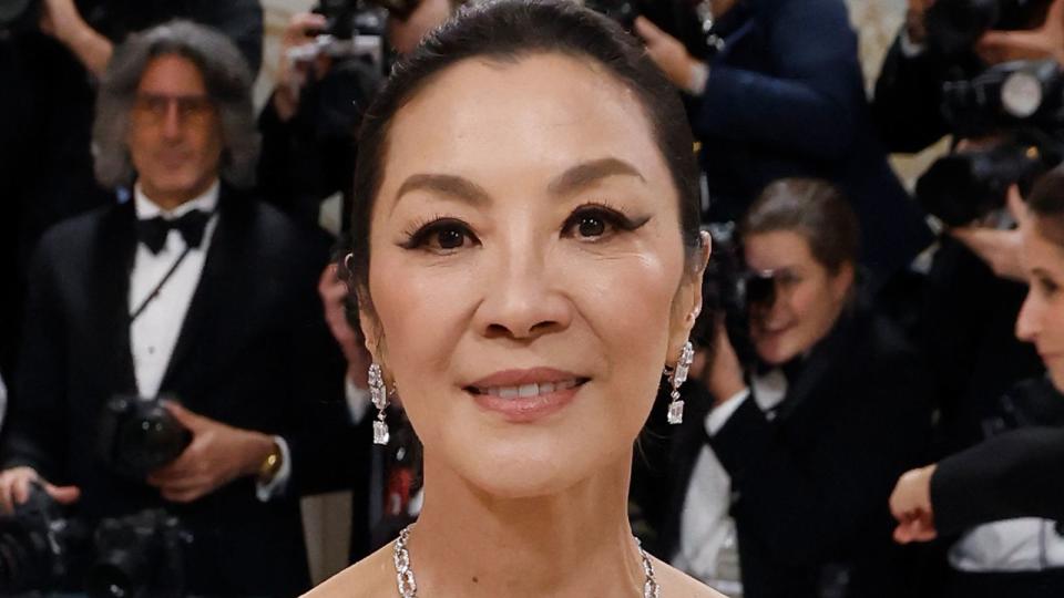 Michelle Yeoh wearing eye makeup looks brown eyes