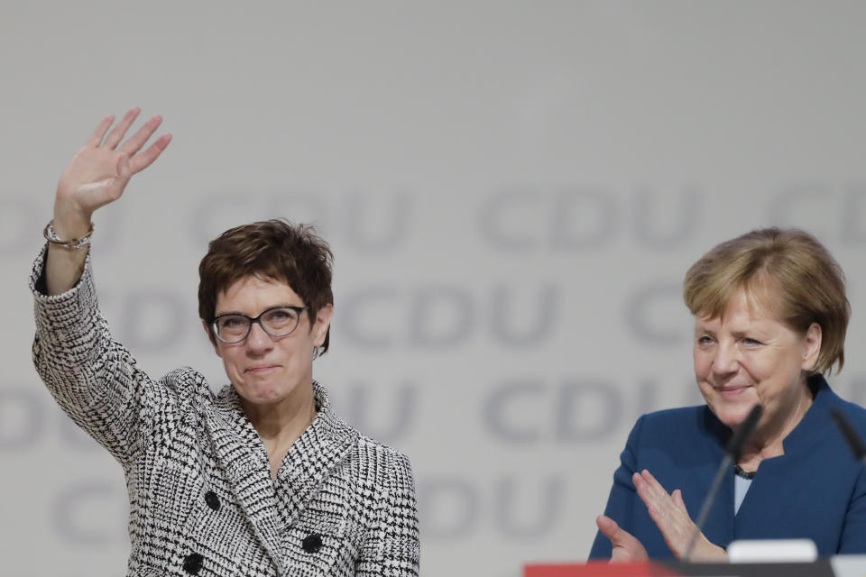 German Chancellor Angela Merkel, right, applauds newly elected party chairwoman Annegret Kramp-Karrenbauer after the election at the party convention of the Christian Democratic Democratic Union CDU in Hamburg, northern Germany, Friday, Dec. 7, 2018. (AP Photo/Markus Schreiber)