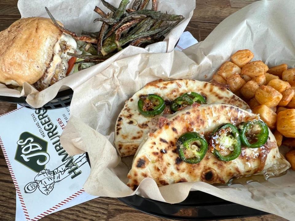 A chicken sandwich, left, and a breakfast sausage-and-jack quesadilla with jalapeno honey at JD’s Hamburgers.