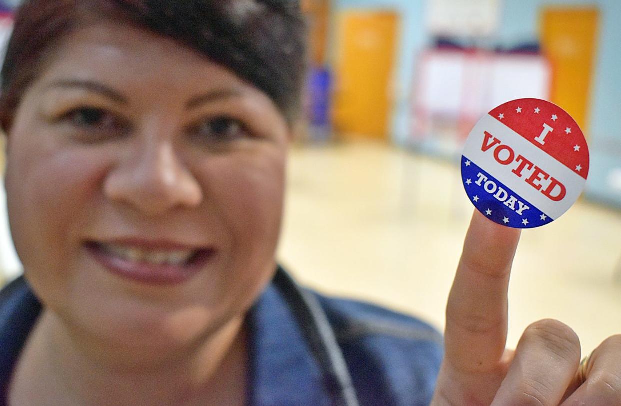 Warden of 9A Nadia Paquette hands out "I voted" stickers at the James Tansey Elementary School polling site in Fall River Tuesday Nov. 7, 2023.
