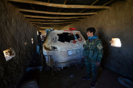 Iraqi paramilitary troops inspect a vehicle used for suicide car bombings, made by Islamic State militants on the outskirts of the ancient city of Hatra near Mosul,Iraq April 26, 2017. REUTERS/Stringer