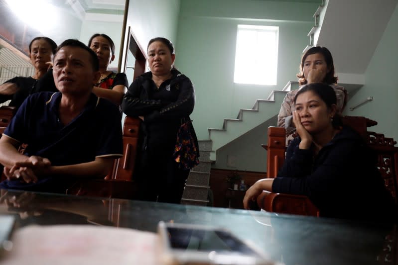 Relatives of Anna Bui Thi Nhung, a Vietnamese suspected victim in a truck container in UK, wait for news about her at her home in Nghe An province